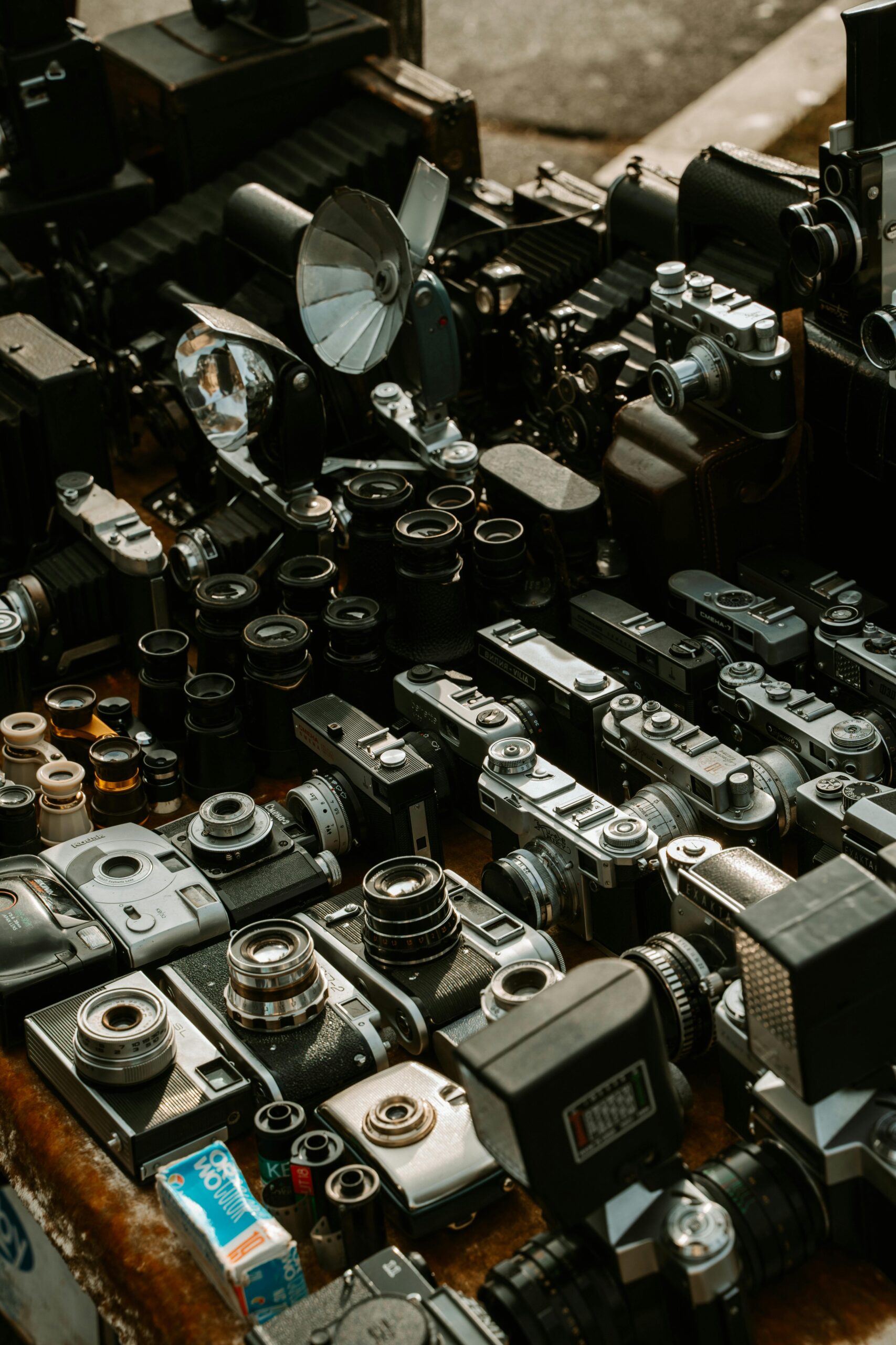 Collection of vintage cameras and accessories at a flea market stall in Sofia, Bulgaria.